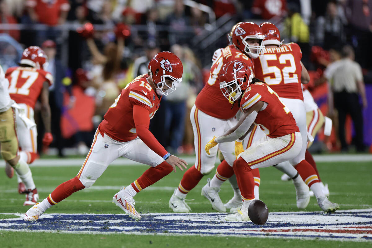 Kansas City Chiefs quarterback Patrick Mahomes (15) lunges for a loose ball during the second h ...