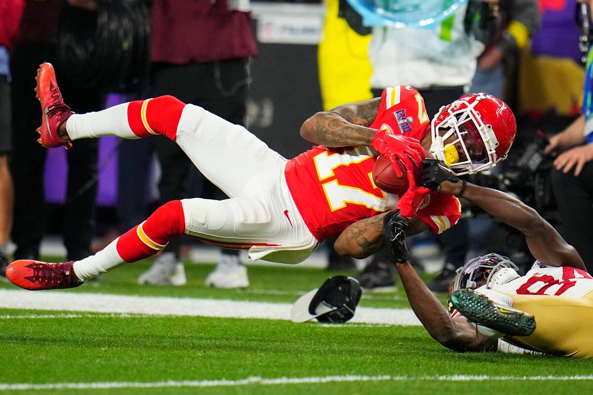 Kansas City Chiefs wide receiver Richie James (17) is hit on a punt return by San Francisco 49e ...