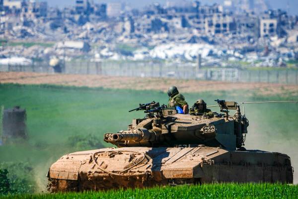 Israeli soldiers drive a tank on the border with the Gaza Strip, as seen in southern Israel, Su ...