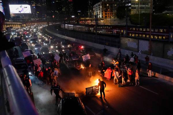 People block a highway during a protest to demand the release of the hostages taken by Hamas mi ...