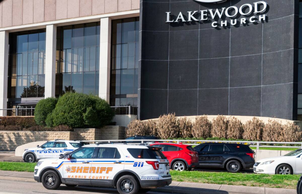 Emergency vehicles line the feeder road outside Lakewood Church during a reported active shoote ...