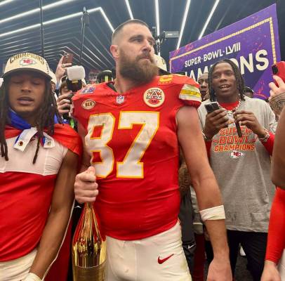 Kansas City Chiefs tight end Travis Kelce celebrates in the team's locker room at Allegiant Sta ...