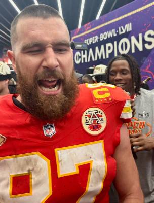 Kansas City Chiefs tight end Travis Kelce celebrates in the team's locker room at Allegiant Sta ...