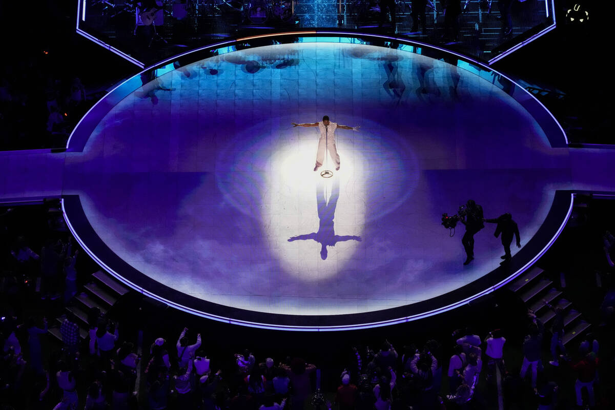 Usher, center, performs during halftime of the NFL Super Bowl 58 football game between the San ...