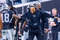 Raiders interim head coach Antonio Pierce celebrates an interception and touchdown with cornerb ...