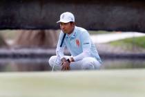 Kevin Na of team Iron Heads GC surveys the green on the 18th during the second round of LI ...