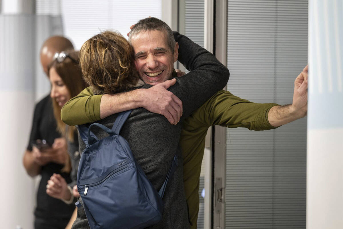 Hostage Fernando Simon Marman, right, hugs a relative after being rescued from captivity in the ...