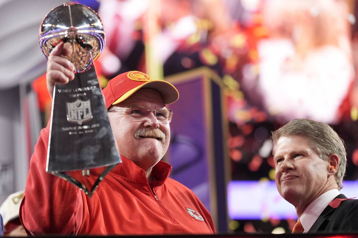 Kansas City Chiefs head coach Andy Reid holds the Vince Lombardi Trophy as Kansas City Chiefs c ...