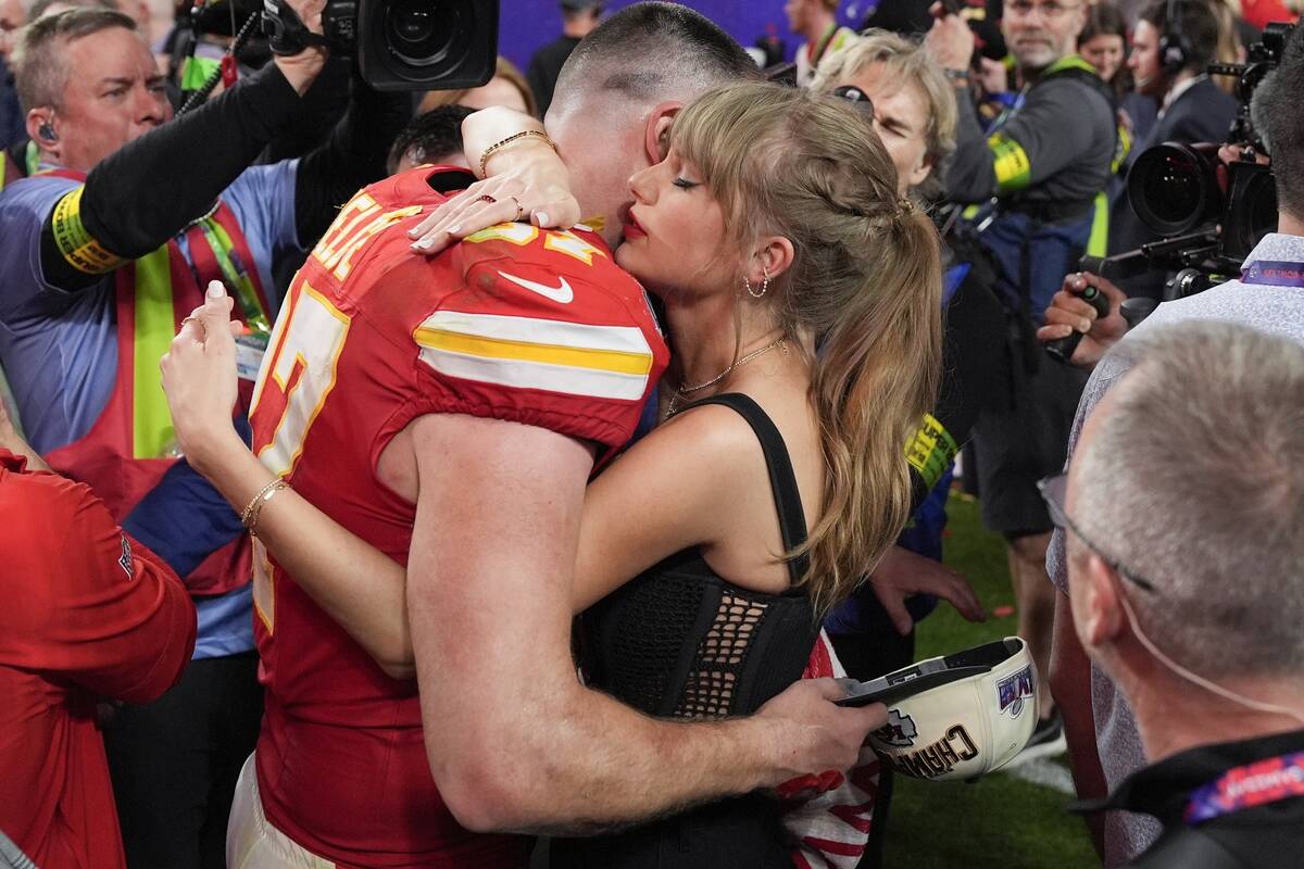 Taylor Swift embraces Kansas City Chiefs tight end Travis Kelce after the NFL Super Bowl 58 foo ...