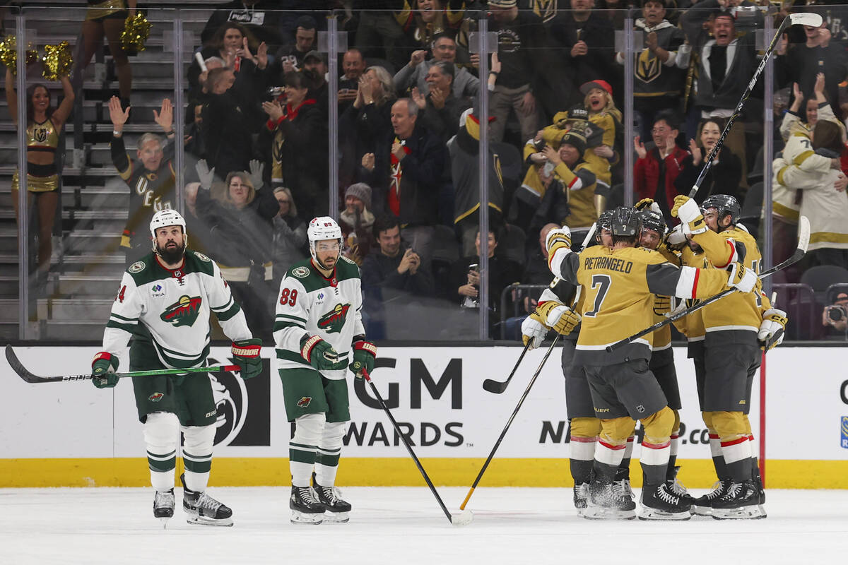 Minnesota Wild defenseman Zach Bogosian (24) and center Frederick Gaudreau (89) look on while V ...