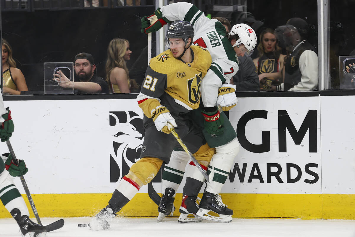 Vegas Golden Knights center Brett Howden (21) collides with Minnesota Wild defenseman Brock Fab ...