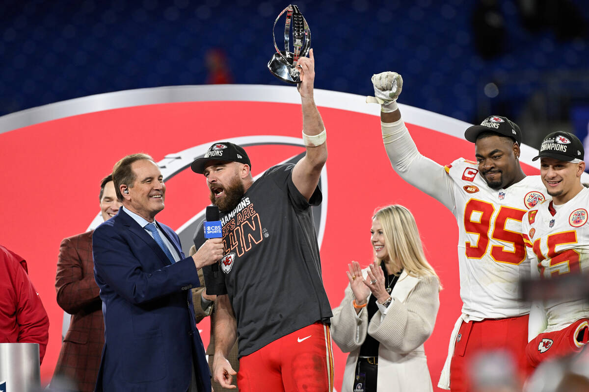 Kansas City Chiefs tight end Travis Kelce talks with CBS announcer Jim Nance and raises the Lam ...