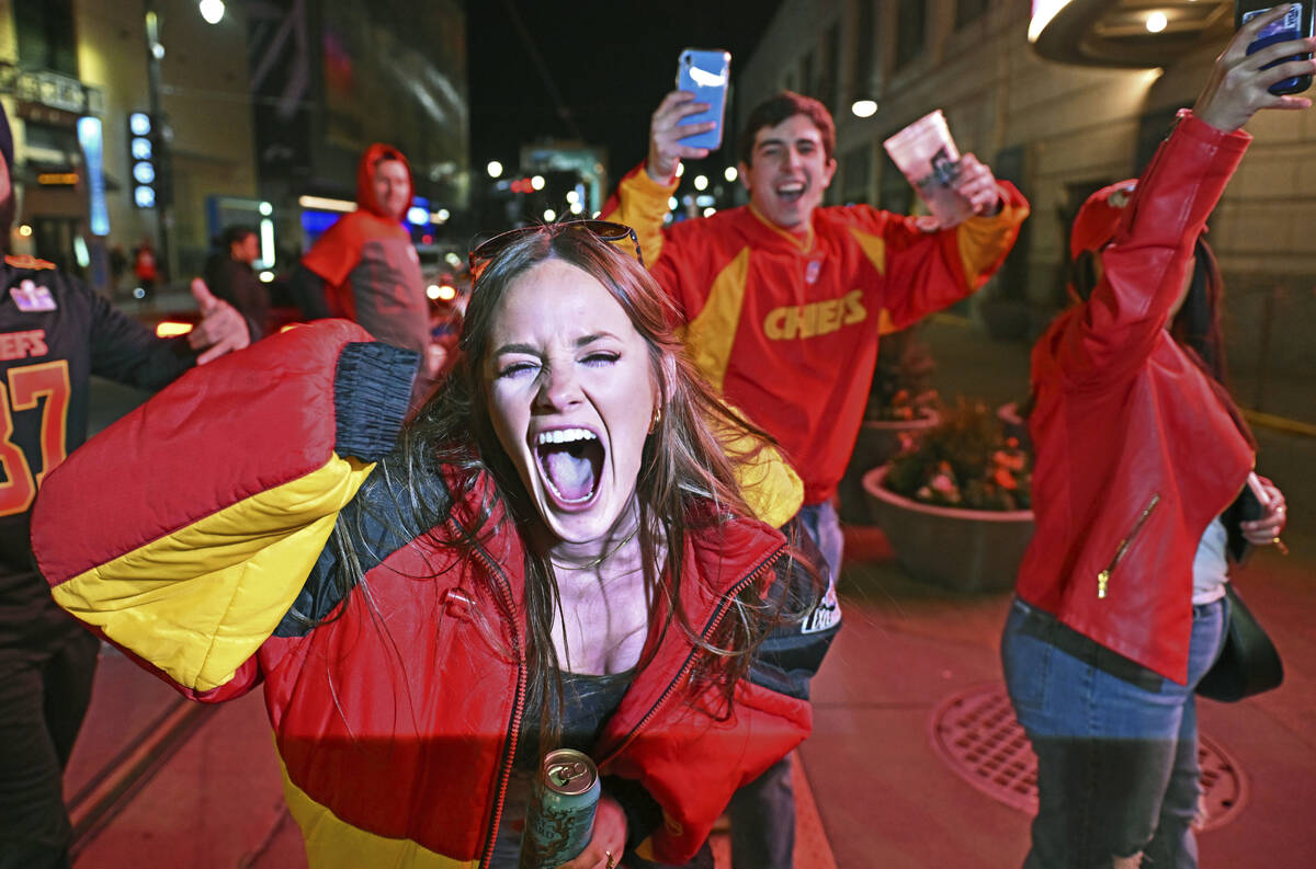 Kansas City Chiefs fans celebrate at the Power and Light District, late Sunday, Feb. 11, 2024, ...