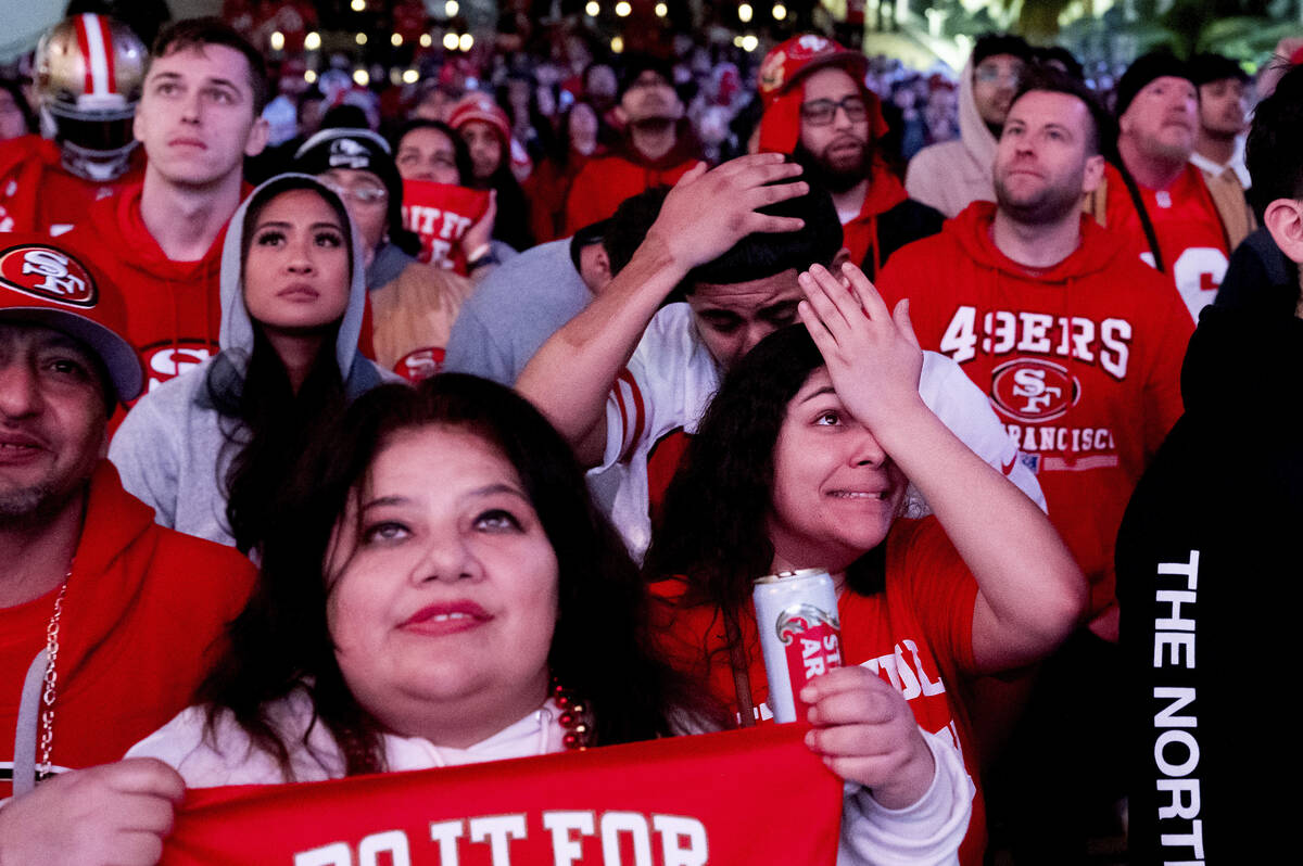 San Francisco 49ers fans react while watching a telecast of NFL football's Super Bowl 58 on a s ...