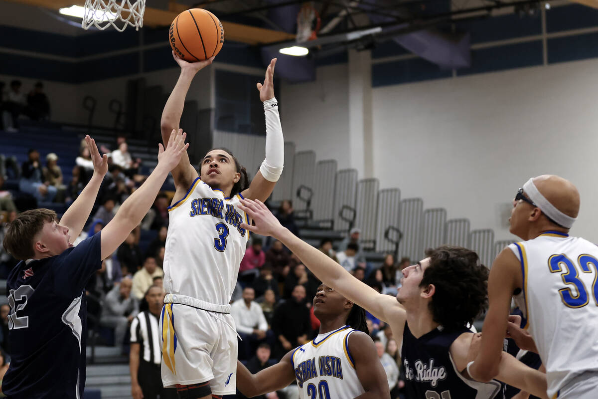 Sierra Vista guard Khamari Taylor (3) shoots against Shadow Ridge forward James Joshua (22) and ...