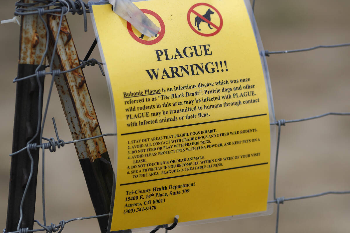 A bubonic plague warning sign is displayed at a parking lot near the Rocky Mountain Arsenal Wil ...