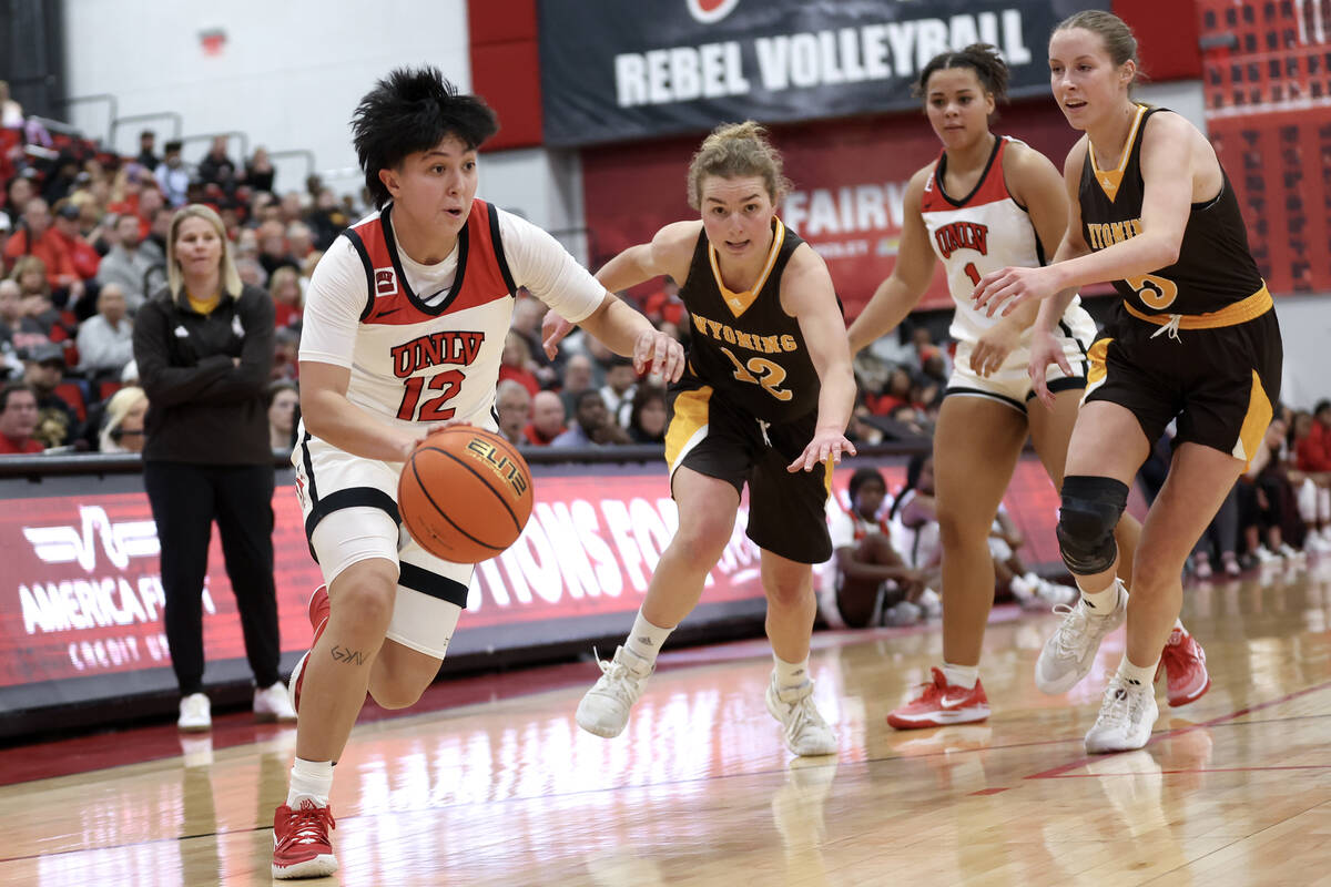 UNLV Lady Rebels guard Alyssa Durazo-Frescas (12) drives toward the hoop while Wyoming Cowgirls ...