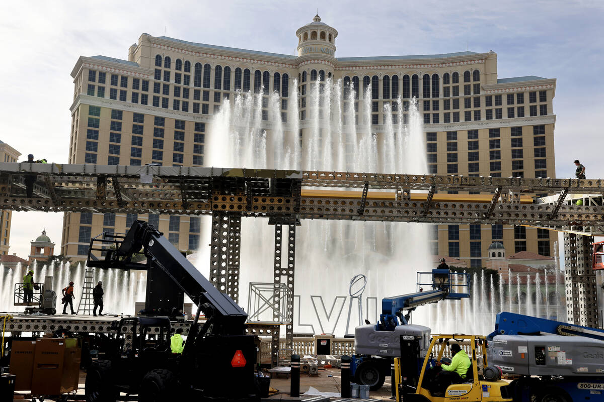 Crews tear down setups from the 2024 Super Bowl at the Bellagio Fountains on the Strip in Las V ...