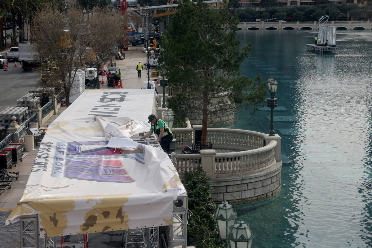 Crews tear down setups from the 2024 Super Bowl at the Bellagio Fountains on the Strip in Las V ...