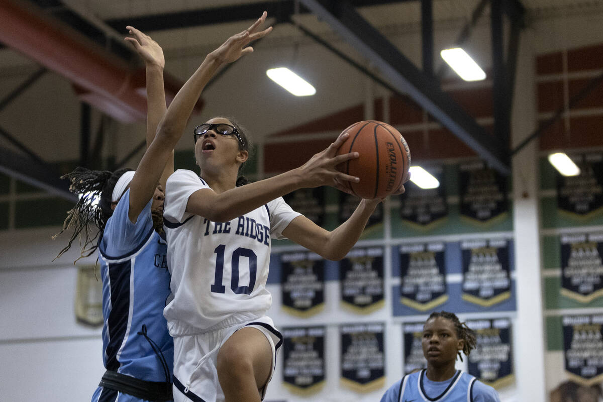 Shadow Ridge’s Jaslyn Jefferson (10) shoots against Centennial’s Saroiya Ajomale, ...