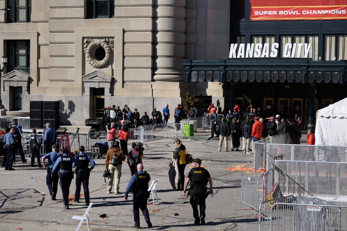 Law enforcement personnel approach Union Station following a shooting at the Kansas City Chiefs ...