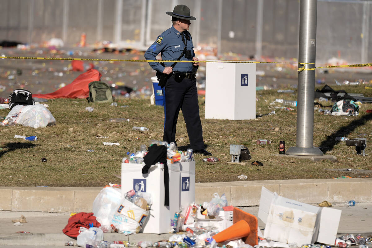 A law enforcement officer looks around the scene after an incident following the Kansas City Ch ...