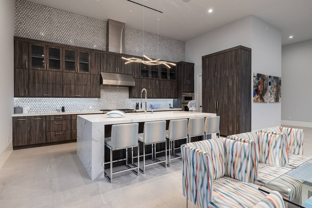 The kitchen has a large island with seating. (JPM Studios)