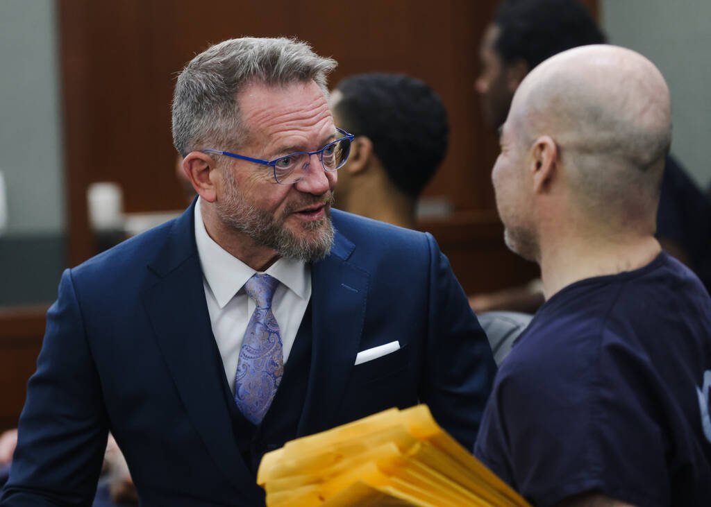 Defense attorney Robert Draskovich, left, speaks with his client Robert Telles, the former publ ...