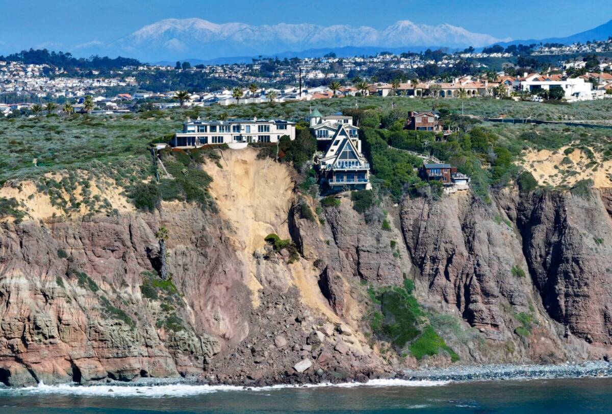 Cliff-top houses along Scenic Drive sit close to a landslide in Dana Point, Calif., on Tuesday, ...