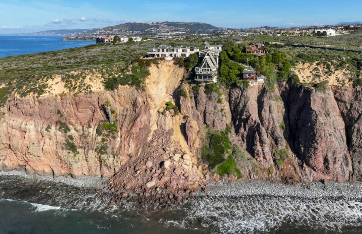 Cliff-top houses along Scenic Drive sit close to a landslide in Dana Point, Calif., on Tuesday, ...