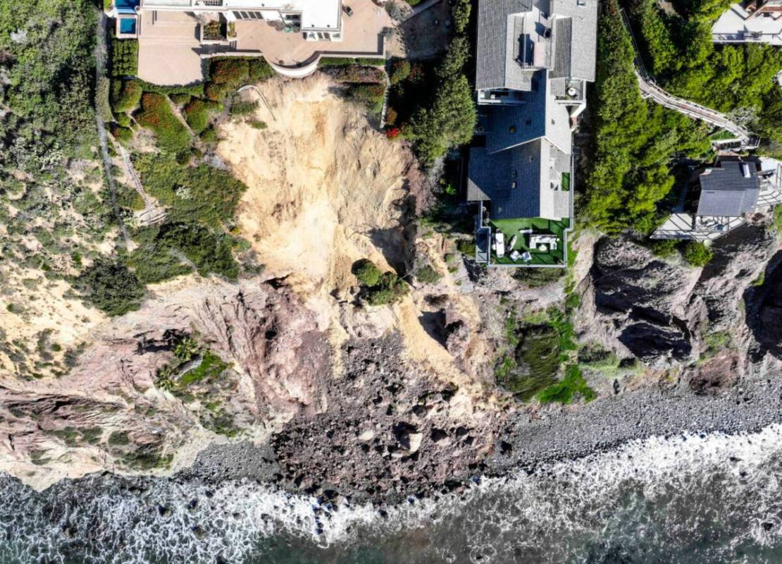 Cliff-top houses along Scenic Drive sit close to a landslide in Dana Point, Calif., on Tuesday, ...