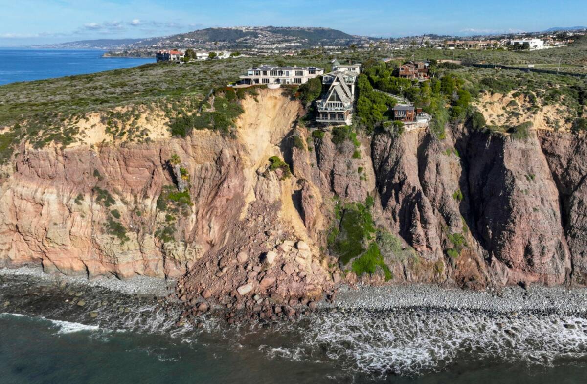 Cliff-top houses along Scenic Drive sit close to a landslide in Dana Point, Calif., on Tuesday, ...