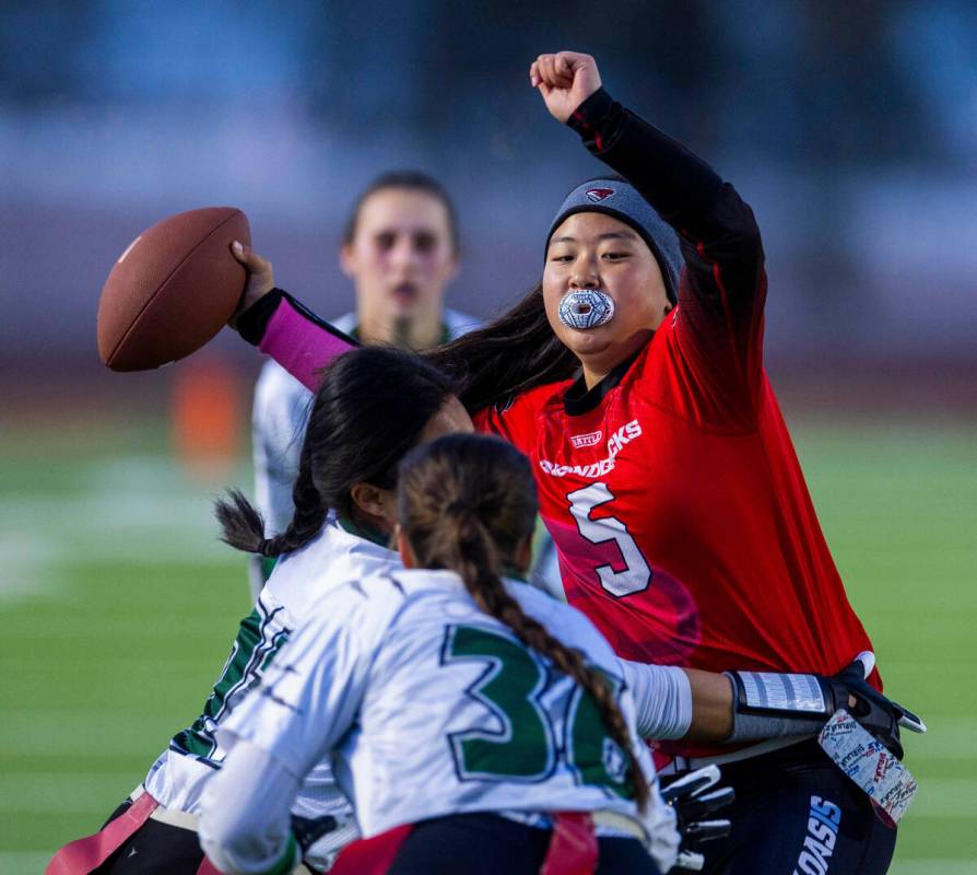 Desert Oasis quarterback Akemi Higa (5) has her flag pulled by Palo Verde defender Madeline Wes ...