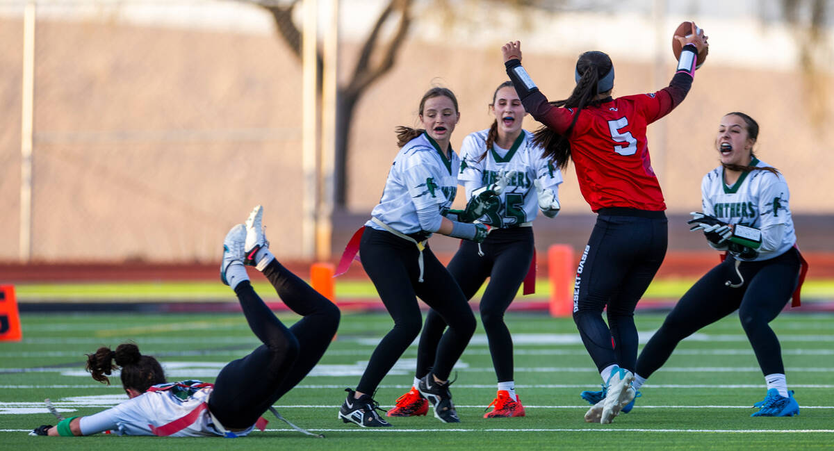 Desert Oasis quarterback Akemi Higa (5) has her flag pulled by a Palo Verde defender during the ...