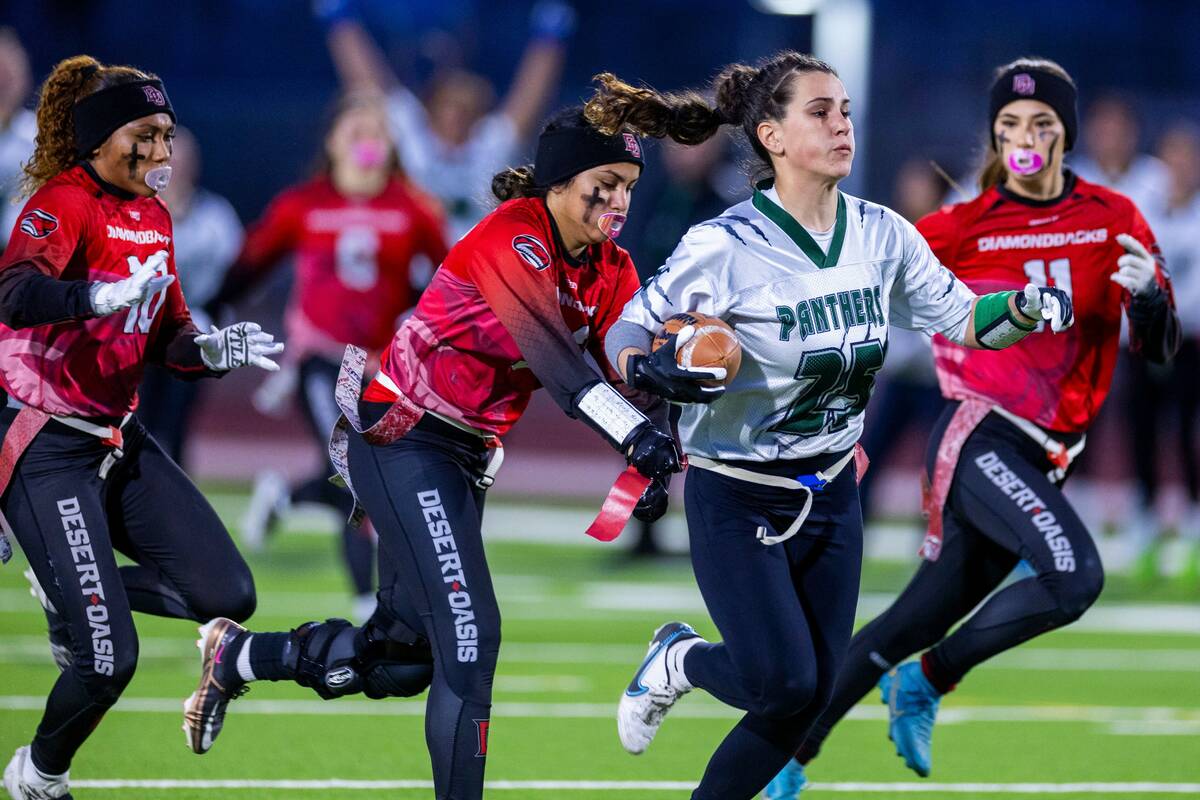 Palo Verde receiver Olivia Perkins (25) makes a long catch while being chased by Desert Oasis d ...