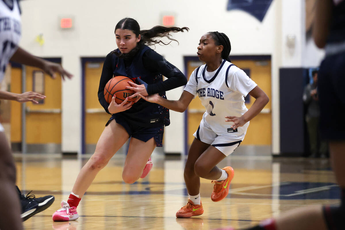 Liberty's Samantha Chesnut (5) dribbles up the court against Shadow Ridge guard Zhoey Reddick ( ...