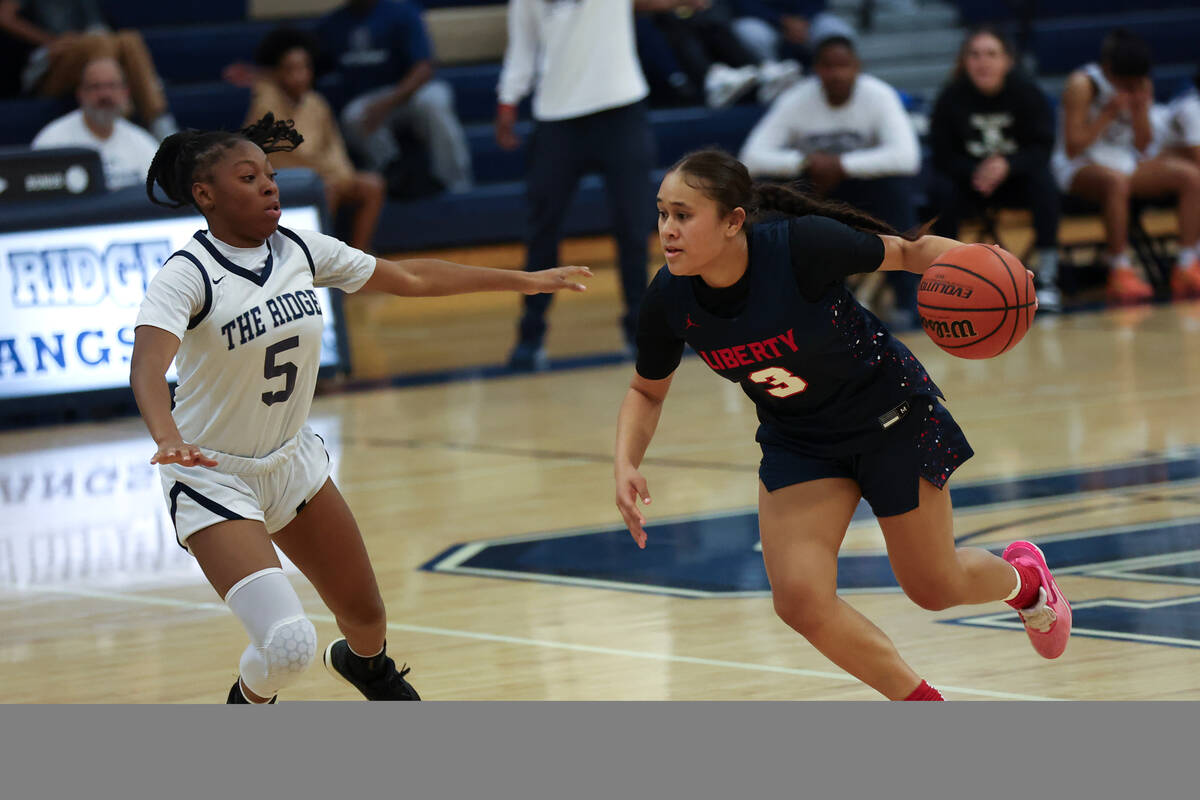 Liberty's Alofa Eteuini (3) drives around Shadow Ridge guard Zh'mya Martin (5) during the secon ...