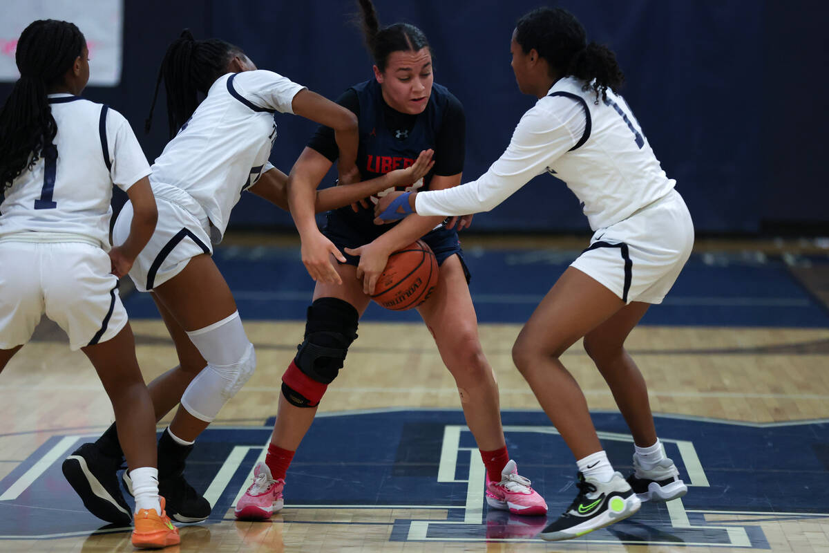 Liberty's Leiliani Harworth (33) fights for possession with Shadow Ridge guard Zh'mya Martin, l ...