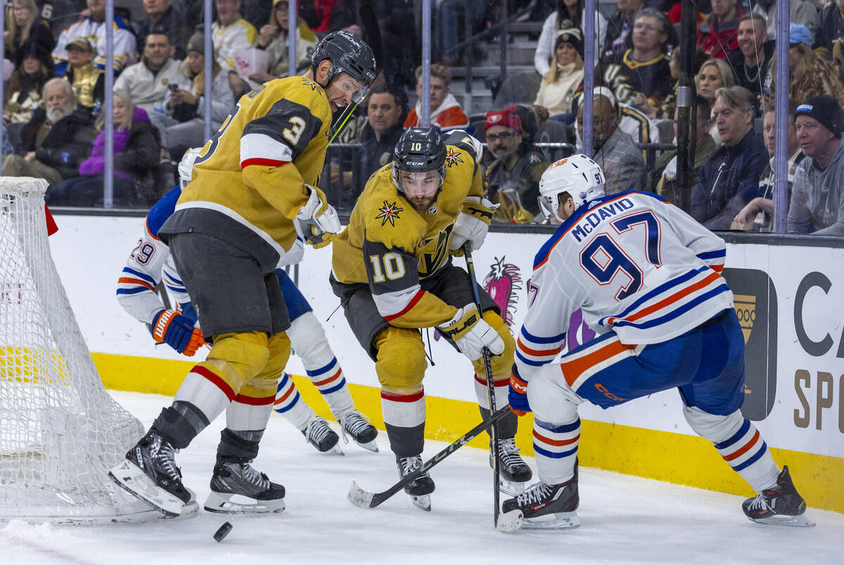 Golden Knights center Nicolas Roy (10) with defenseman Brayden McNabb (3) pass the puck away fr ...