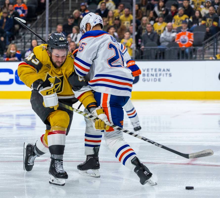 Golden Knights center Paul Cotter (43) is checked by Edmonton Oilers defenseman Darnell Nurse ( ...