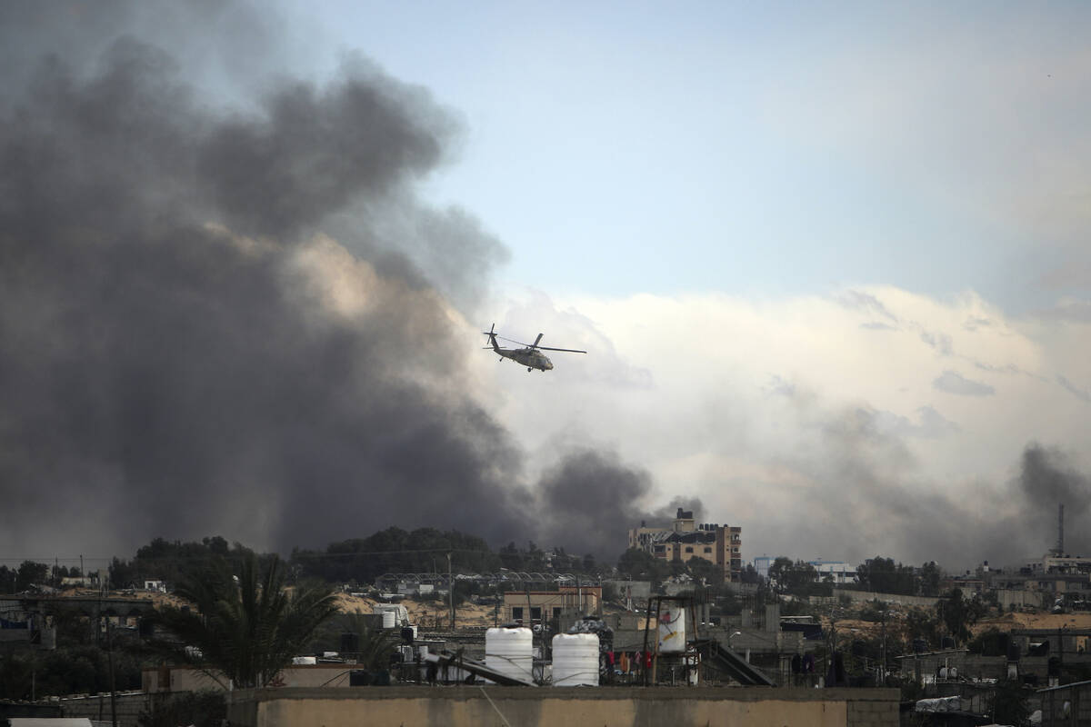 Israeli helicopter flies over Khan Younis, Gaza Strip, Thursday, Feb. 15, 2024. (AP Photo/Moham ...