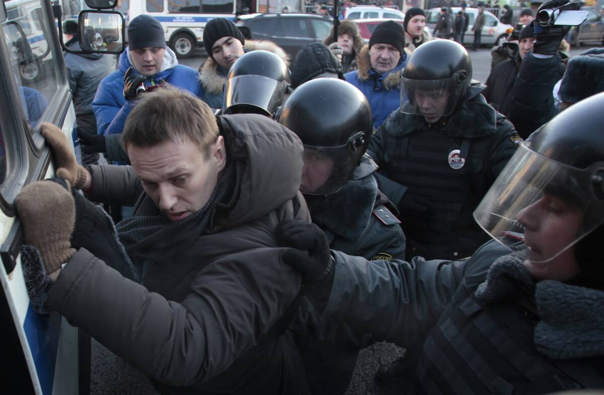 FILE - Police officers detain opposition leader Alexei Navalny during an unauthorized rally in ...