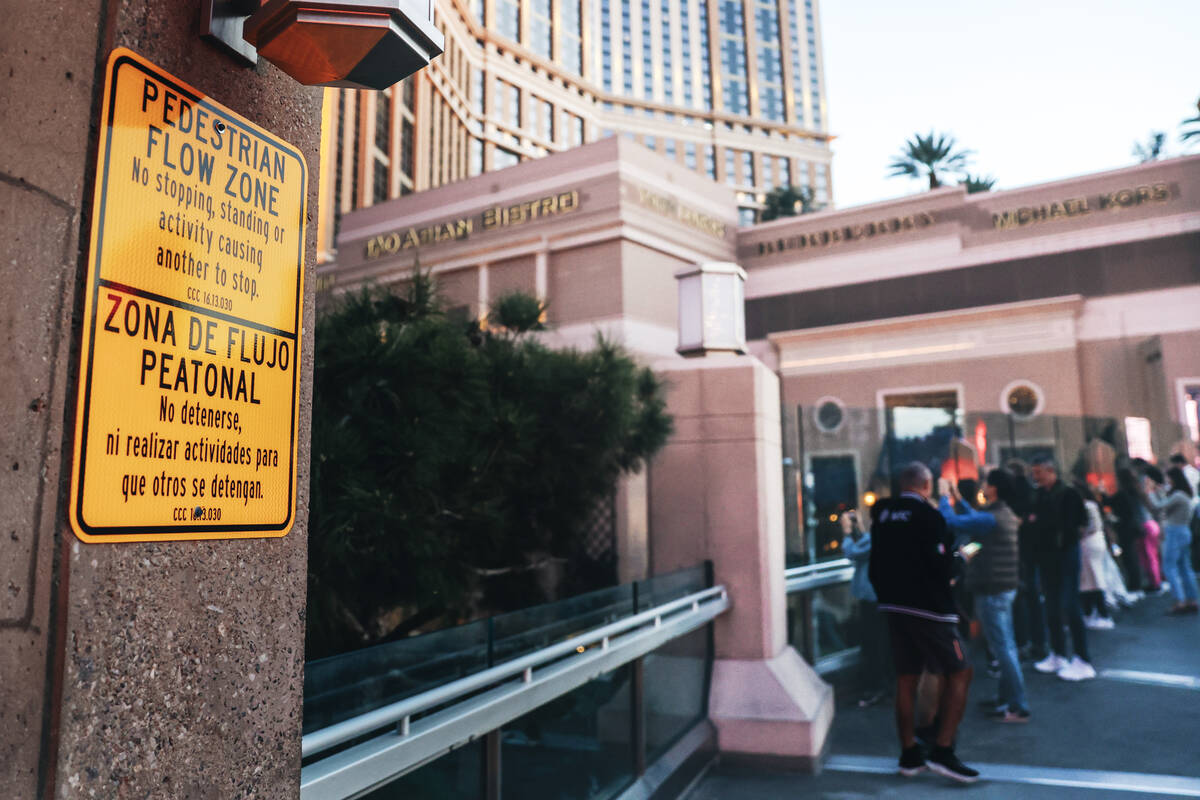 A sign notifies people that stopping on pedestrian walkways is not allowed on Friday, Feb. 16, ...