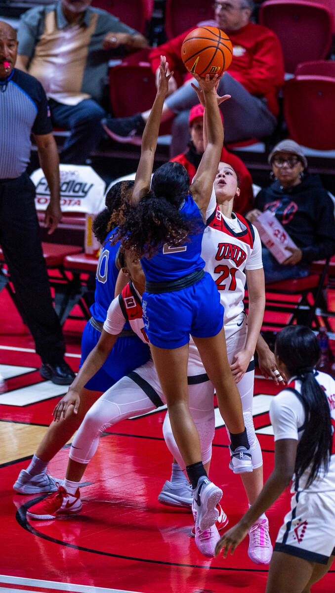 UNLV Lady Rebels forward McKinna Brackens (21) rejects a shot from Air Force Falcons guard Mila ...