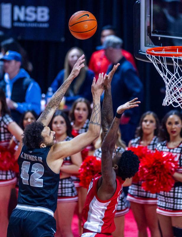 UNR forward K.J. Hymes (42) shoots over UNLV Rebels forward Kalib Boone (10) for a score during ...