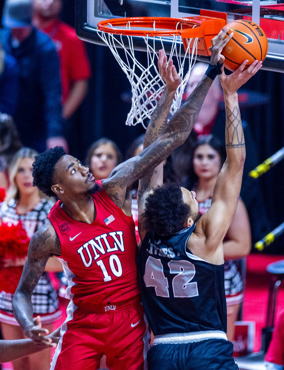 UNLV Rebels forward Kalib Boone (10) rejects a shot by UNR forward K.J. Hymes (42) during the f ...