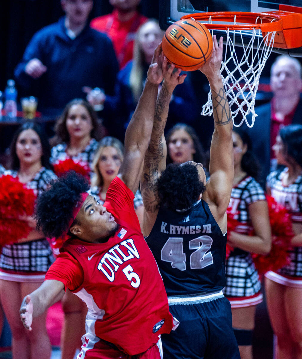 UNLV Rebels forward Rob Whaley Jr. (5) rejects a shot by UNR forward K.J. Hymes (42) during the ...