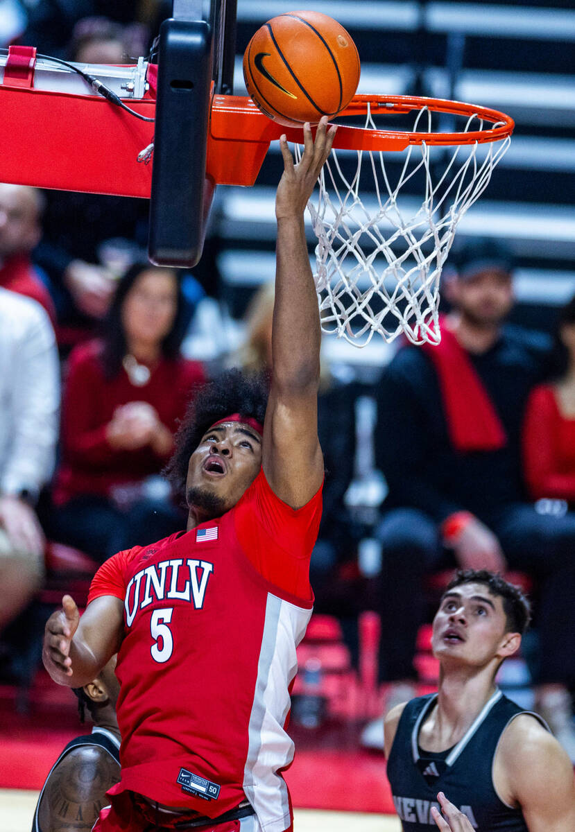 UNLV Rebels forward Rob Whaley Jr. (5) lays in the ball over UNR forward Nick Davidson (11) dur ...