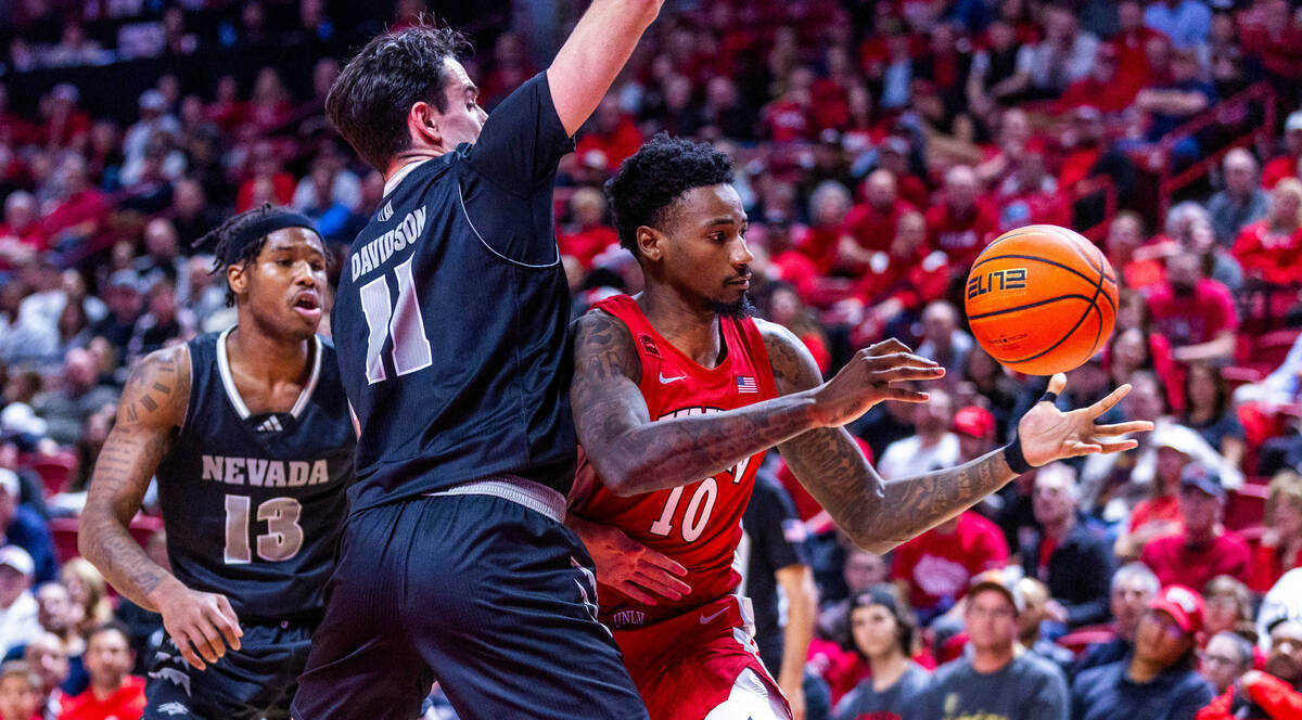 UNLV Rebels forward Kalib Boone (10) loses the ball on a foul from UNR forward Nick Davidson (1 ...
