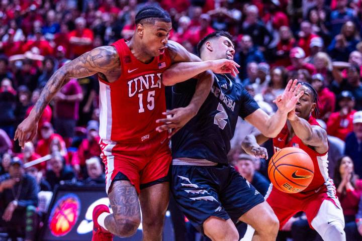 UNLV Rebels guard Luis Rodriguez (15) fouls UNR guard Jarod Lucas (2) sending him to the line l ...